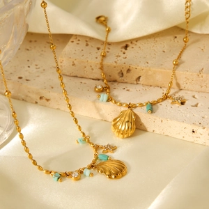 Golden seashell and star pendant necklace with amazonite beads on silk fabric