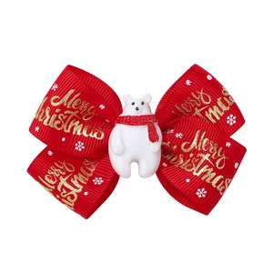 Detail of red Christmas hair bow with white polar bear and golden Merry Christmas text