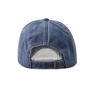 Detail view of washed denim baseball cap back with metal buckle and white stitching