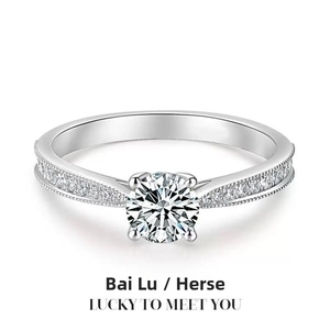 Elegant silver ring with a round brilliant cut stone and a sparkling pavé diamond band.