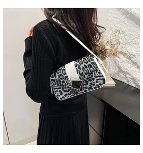 Detail of grey leopard print shoulder bag with white flap and gold geometric buckle