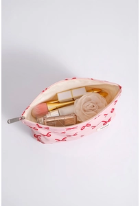 Top view of pink bow canvas makeup bag showing spacious storage for brushes and palettes
