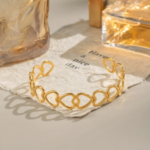 Gold heart cutout open bangle made of 18K plated stainless steel with high-polished finish