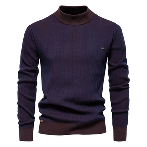 Detail of the blue vertical stripes and red-brown ribbed cuffs on the knitted sweater