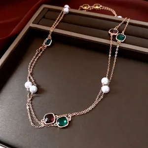 Vintage multi-layer gold necklace with pearls and colorful gemstones on red silk