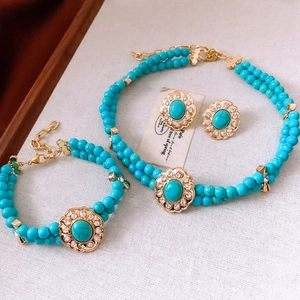 Dettaglio del set di gioielli vintage con perle turchesi e accenti in strass lucidi