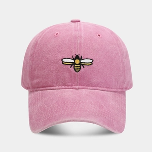 Close-up of pink bee embroidery on a vintage washed cotton baseball dad hat