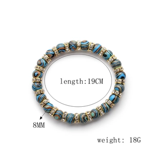 Macro view of 8mm malachite beaded bracelet with sparkling gold rhinestone spacers