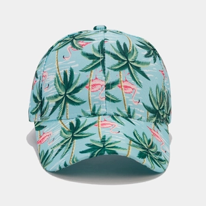 Close-up of tropical print baseball cap featuring pink flamingos and palm trees