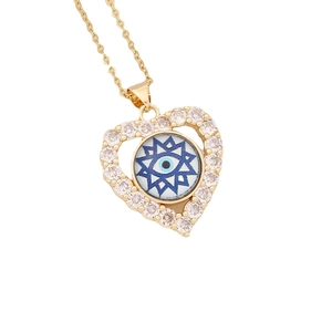 Gold heart evil eye necklace featuring micro-pave cubic zirconia on white background