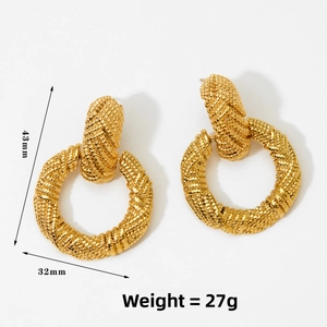 Macro detail of large gold woven texture earrings with dimensions 43mm by 32mm