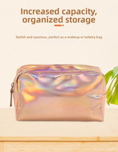 Close-up of holographic laser makeup bag with metal zipper on a wooden surface