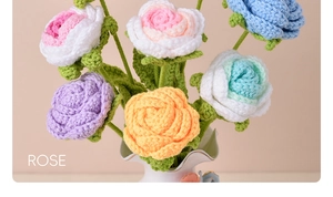 Close-up of handmade crochet roses in a vase showing detailed yarn texture