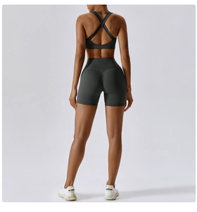 Dettaglio delle spalline incrociate del reggiseno sportivo grigio antracite e shorts