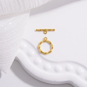 Macro shot of gold-plated S925 silver OT toggle clasp connector on white silk