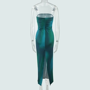 Detail view of ruched back and high slit on dark green gradient strapless maxi dress