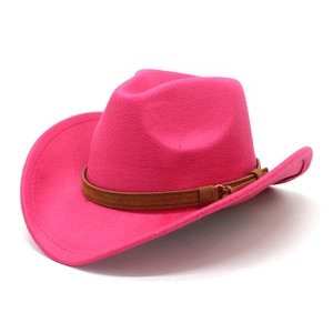 Detail of rose red felt cowboy hat featuring a brown suede band and metal buckle accents