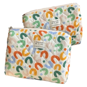 Quilted cotton cosmetic bag with vibrant colorful arch patterns and a metal zipper