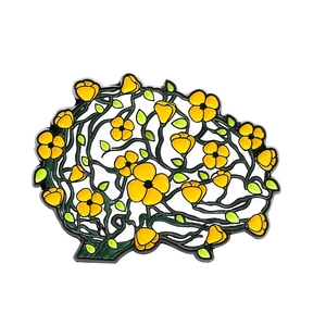 Human brain enamel pin with yellow flowers and green leaves on a clean white background