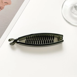 Close-up of black plastic banana hair clip with internal teeth for secure ponytail grip