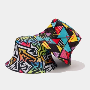 Close-up of reversible bucket hats with vibrant 90s retro geometric patterns and graffiti print