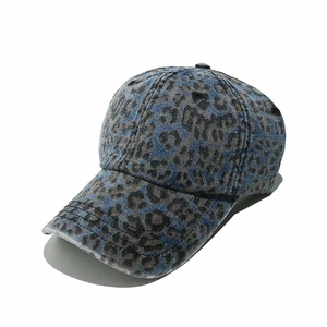 Close-up of washed denim baseball cap with leopard print and vintage blue gray texture