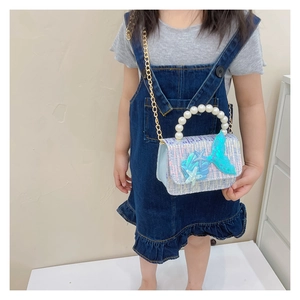 Detail of girls mermaid sequin handbag with pearl handle and golden chain strap