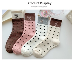 Close-up of four-pack polka dot socks with bow embroidery in various pastel colors