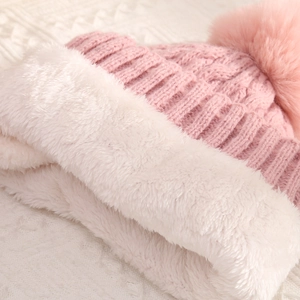 Winter chunky knit beanie for women with warm faux fur lining and pink pompom detail