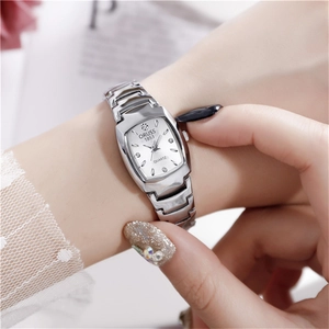 Close-up of elegant tonneau-shaped women quartz watch with silver steel band on wrist