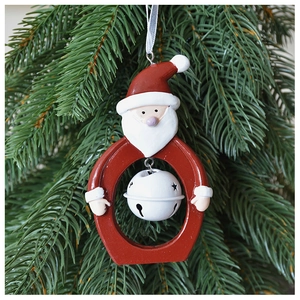 Detailed close-up of a Santa Claus resin frame with white hollow star bell on a Christmas tree