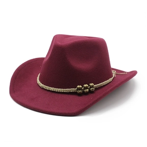 Detail of burgundy wool felt cowboy hat with beige braided rope and gold beads decoration