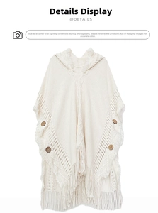 Detailed knit texture and wooden buttons on bohemian cream hooded poncho with tassels