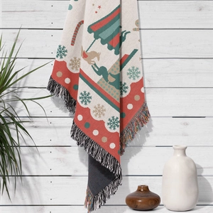 Macro detail of Christmas theme woven blanket with festive patterns and fringe edges