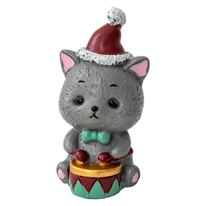 Christmas kitten figurine in festive red hat and bow tie for holiday table decoration