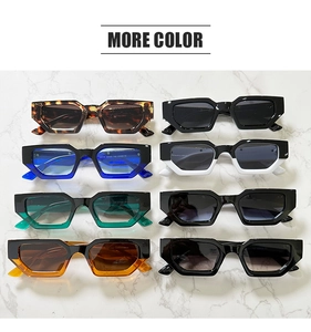Overhead view of various retro square sunglasses in multiple colors on marble background