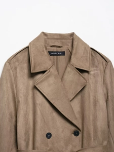 Detail of brown faux suede trench coat featuring double-breasted buttons and epaulettes