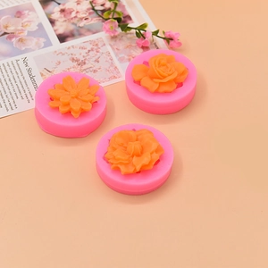 Pink silicone molds for floral fondants and soaps including rose and daisy designs