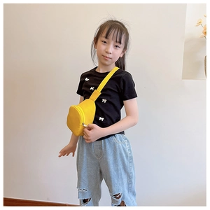 Kids yellow crossbody chest bag made of nylon fabric shown on model in studio setting