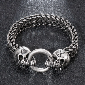 Close-up of retro skull charms on a double-row men's stainless steel punk bracelet