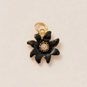 Macro shot of 18K gold-plated black enamel flower pendant with sparkling zircon center
