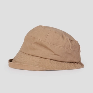 Close-up of khaki cotton bucket hat showing quilted stitching details and rolled brim