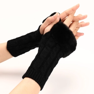 Close-up of black cable knit fingerless gloves featuring soft faux fur trim for winter