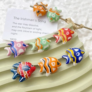 Hand-painted colorful ceramic goldfish beads for DIY jewelry making on white background