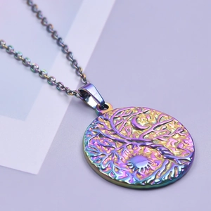 Macro shot of 18K gold rainbow stainless steel Tree of Life pendant with sun moon details