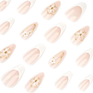 French almond press-on nails with 3D floral elements and gold beads on nude base