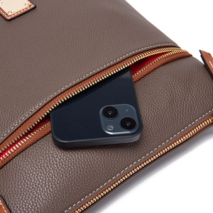 Detailed close-up of dark brown pebble leather bag with zipper pocket and phone compartment