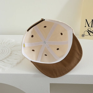 Interior view of children's cotton baseball cap with reinforcing tape and brand tag
