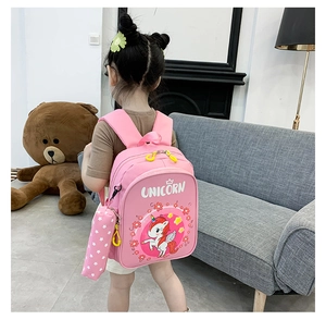 Pink unicorn kids backpack with matching pencil case shown worn by a young girl