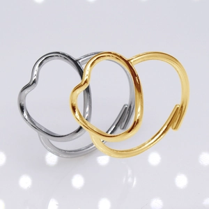 Detailed view of silver and gold open heart rings with organic lines and metallic shine